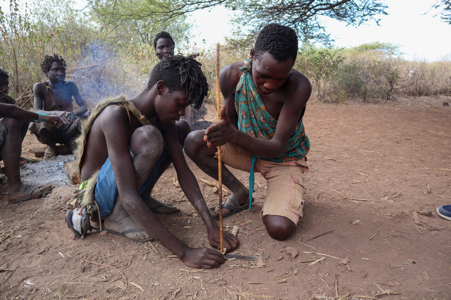 Datoga blacksmith crafting traditional metal tools beside Lake Eyasi using ancestral forging techniques daily.