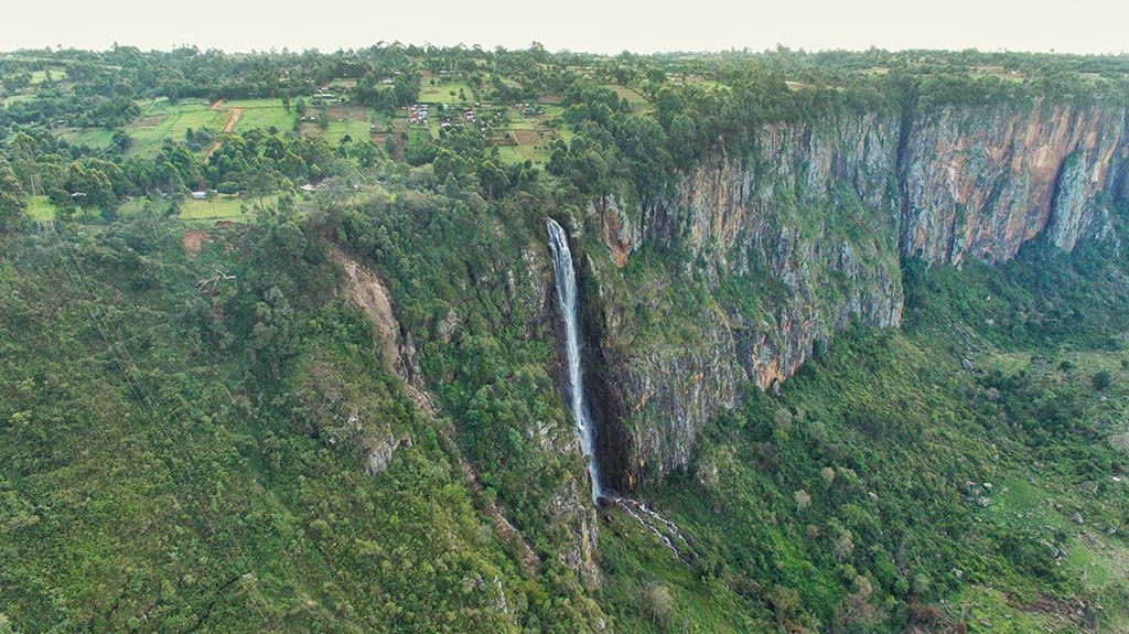 Scenic viewpoint revealing dramatic cliffs overlooking lush Kerio Valley beneath clear blue skies