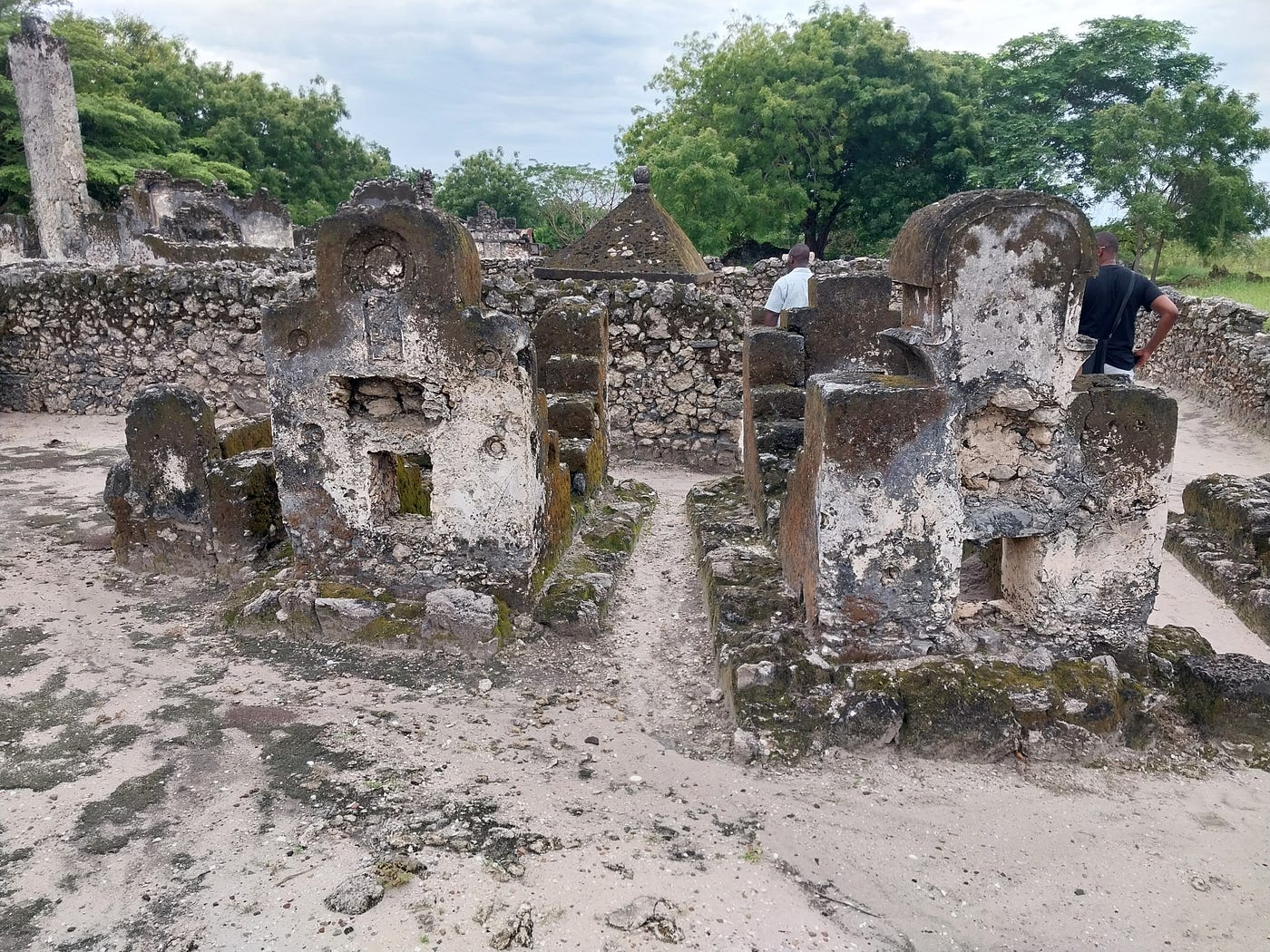 Ancient Bagamoyo mission buildings preserving Tanzania's coastal history beside towering palm trees overlooking ocean