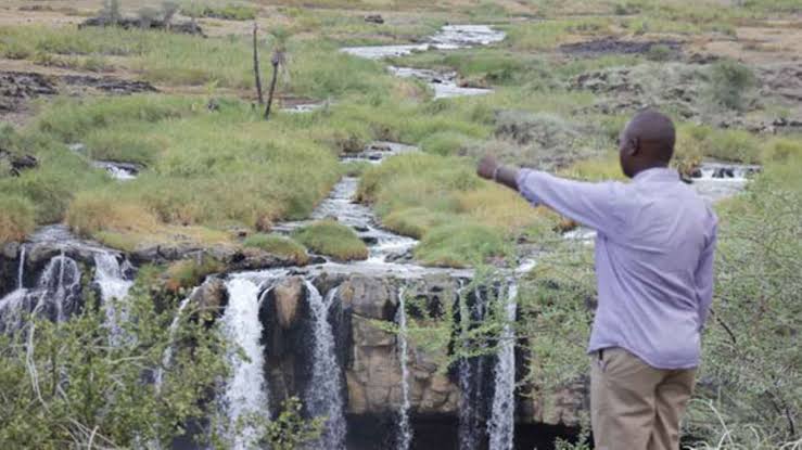 Steam rises from Kapedo Hot Springs surrounded by rugged volcanic landscapes in northern Kenya.