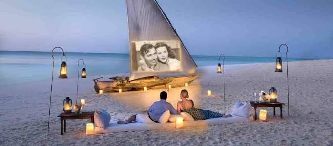 Romantic beachfront resort overlooking turquoise Zanzibar ocean with palm trees at sunrise