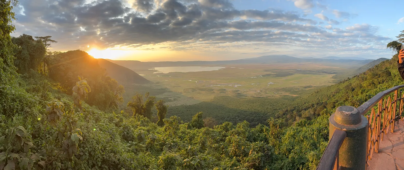 Klipspringer Point overlooking Ngorongoro Highlands during a colorful sunrise above misty valleys and forests