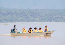 Tourists enjoying boat ride across Lake Baringo while spotting birds and wildlife together.