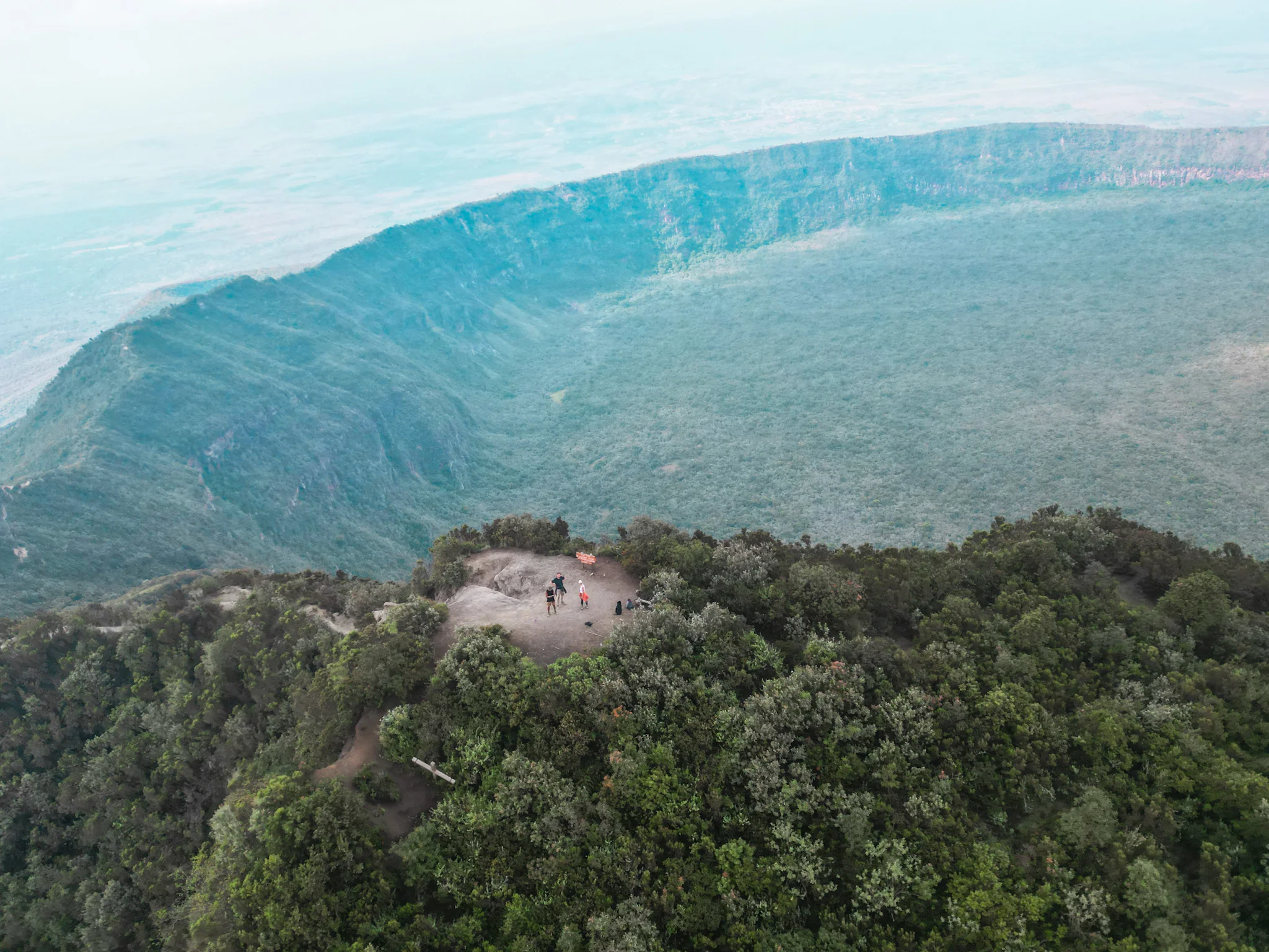 Aerial overview of Mount Longonot's volcanic crater surrounded by the Great Rift Valley landscape near Lake Naivasha, Kenya."