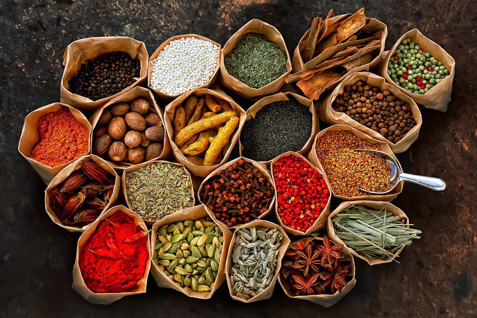Fresh cloves, cinnamon sticks, vanilla pods, and tropical spices displayed during Zanzibar farm tour experience.