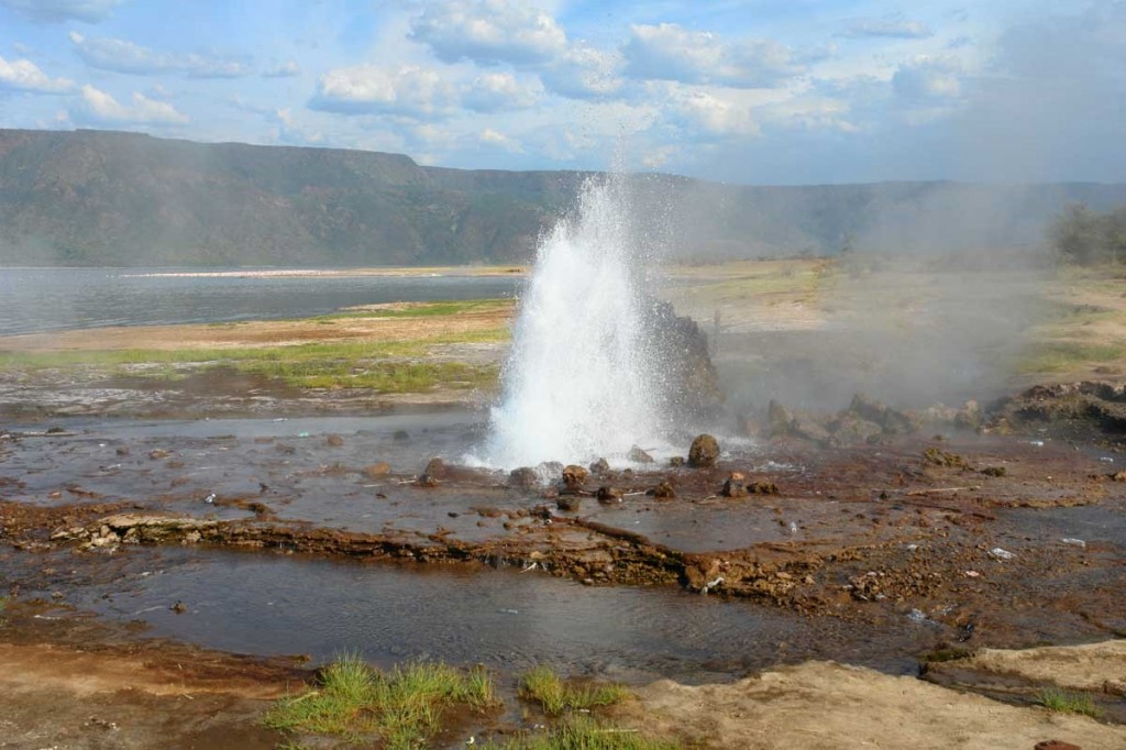 Lake Bogoria hot springs releasing steam across Kenya’s dramatic Rift Valley scenery.