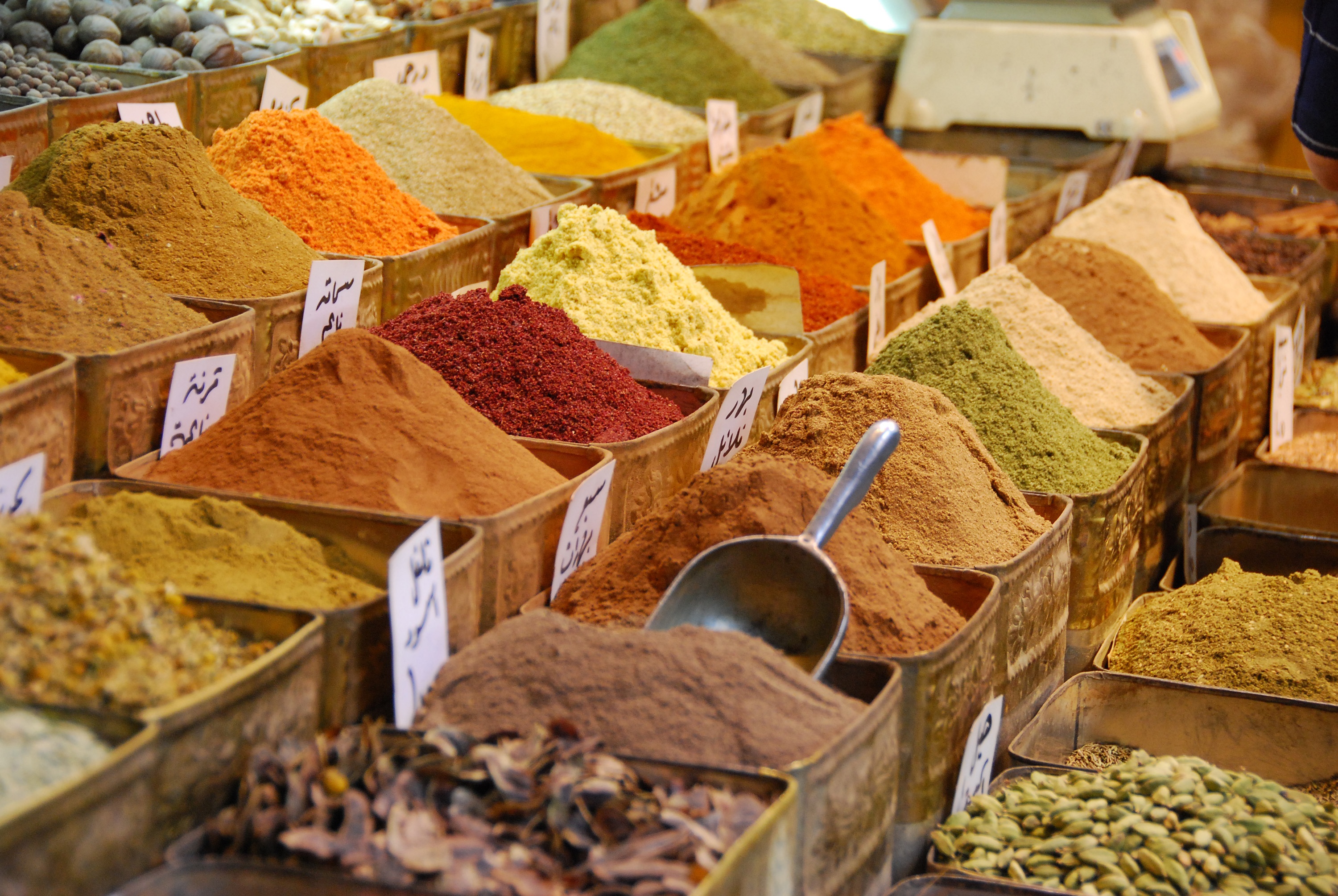 Colorful spices, fresh tropical fruits, fragrant herbs arranged on traditional Zanzibar table.