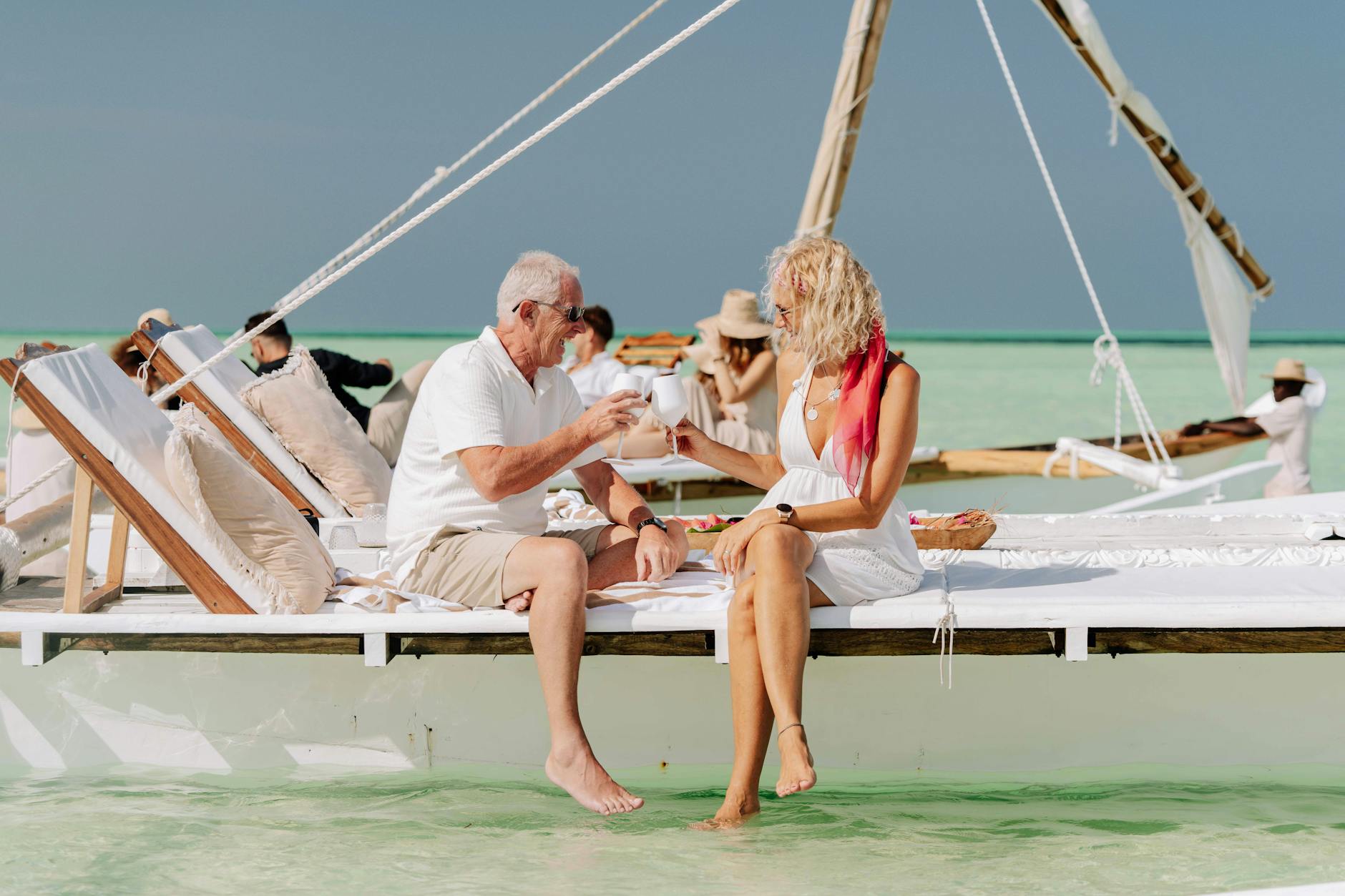 Romantic couple walking along Zanzibar beach beside affordable honeymoon resort during golden sunset together