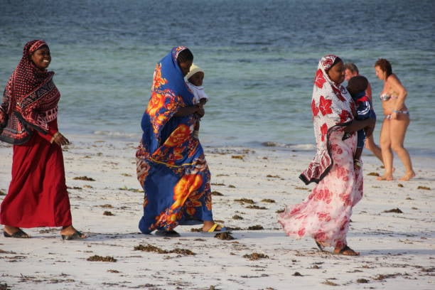 Beautiful Zanzibar beach resort guests enjoying peaceful Ramadan evening atmosphere together respectfully.
